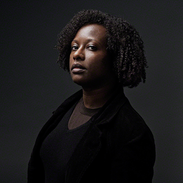 striking portrait against dark background, stark, strong, powerful, black female