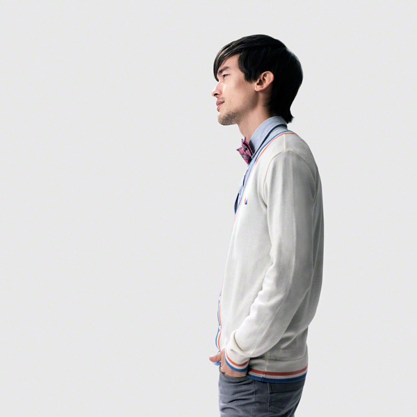 neutral, profile shot, portrait against white background, boyish, asian male wearing a bow tie