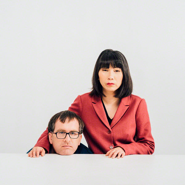 in studio portrait against white background, humorous, portrait, square format, vivid, unique, original, couple