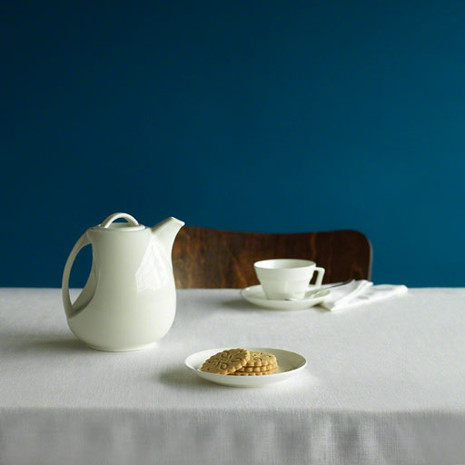 still life of classic white tea pot with cups, editorial