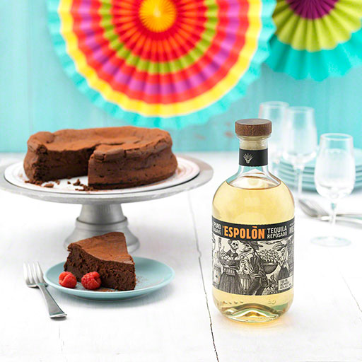 chocolate cake baked with tequila next to a bottle