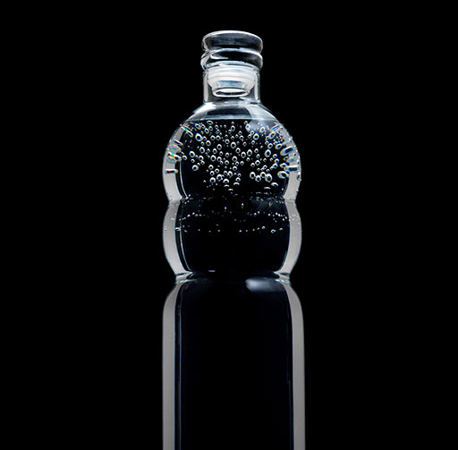  still life photo, dramatic, low key, glass water bottle on black background, home accessories, homewares