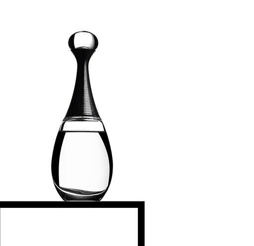 dramatic, low key black and white photo of perfume bottle