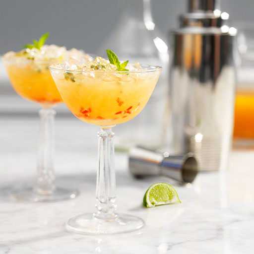 editorial photo of cocktail with shaker in background