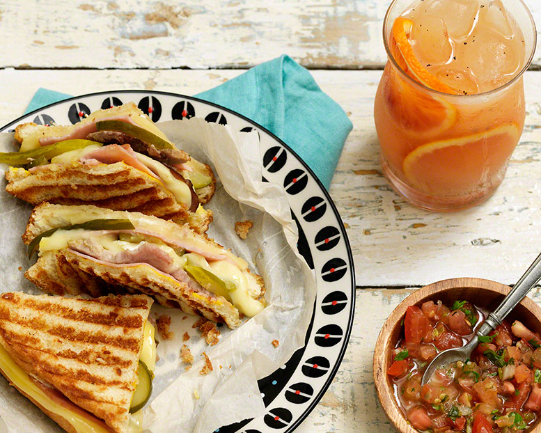 overhead shot of cuban sandwiches with cocktail, food editorial