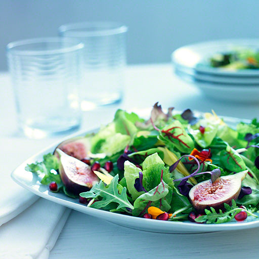 fresh, clean open light salad with figs and pomegranites food photo, editorial