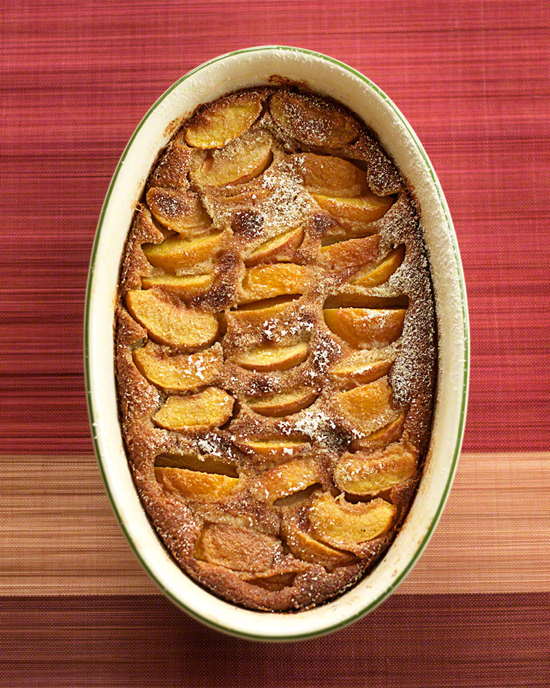 editorial, overhead shot of a freshly baked peach Clafoutis dessert
