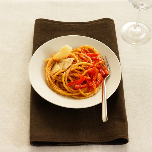 plate of spaghetti with tomato pesto on constrasting background, editorial, food photograph