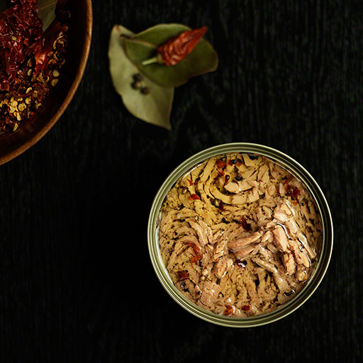 can of tuna in olive oil with chili peppers, overhead pov, product still life, editorial