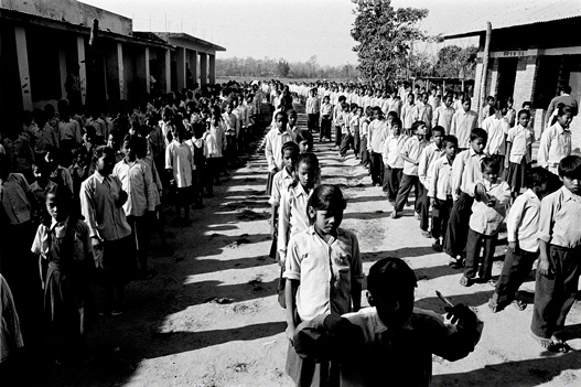 middle school boys and girl lineup for their morning exercises in schoolyard