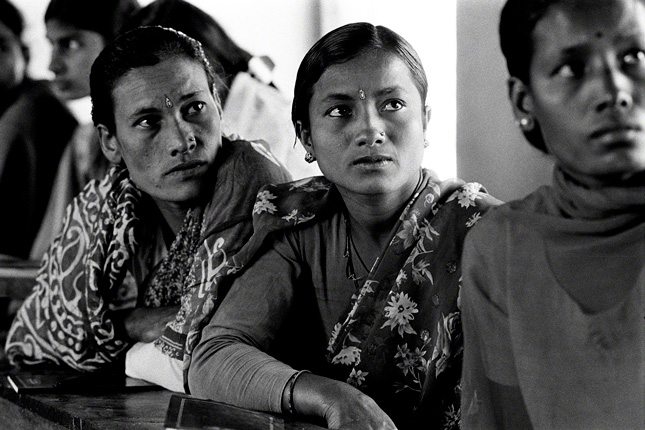 closeup of nepalese women attending empowerment classes listen intently