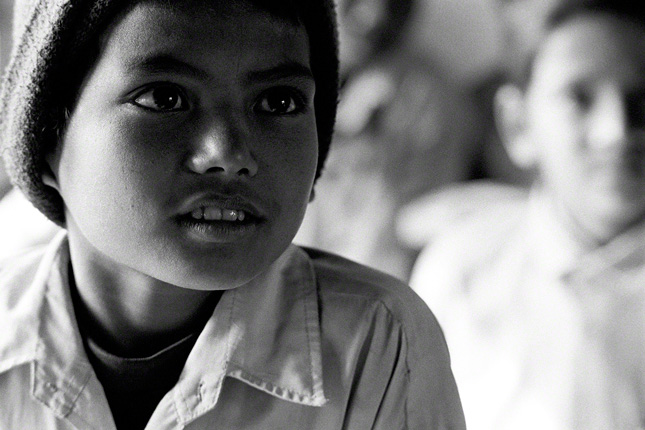 extreme closeup of young nepalese boy in class