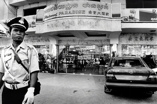 police guard a mercedes car outside a store in phnom penh