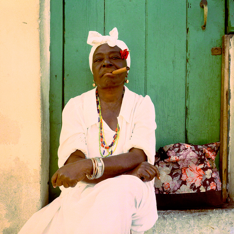 portrait of a Afro-cuban lady smoking a cigar in Havana